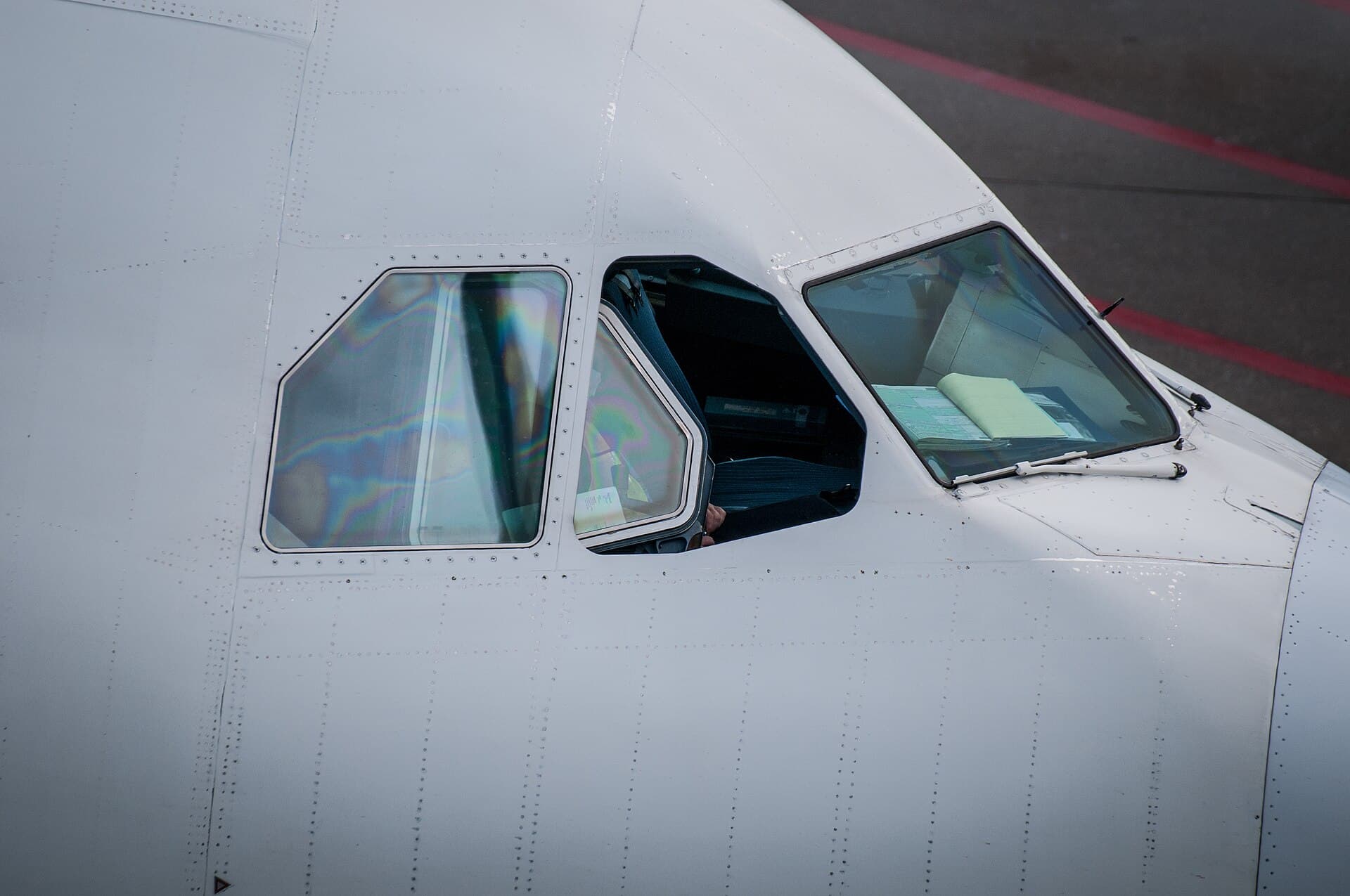 Passenger aircraft parked at terminal stands on a busy airport apron.